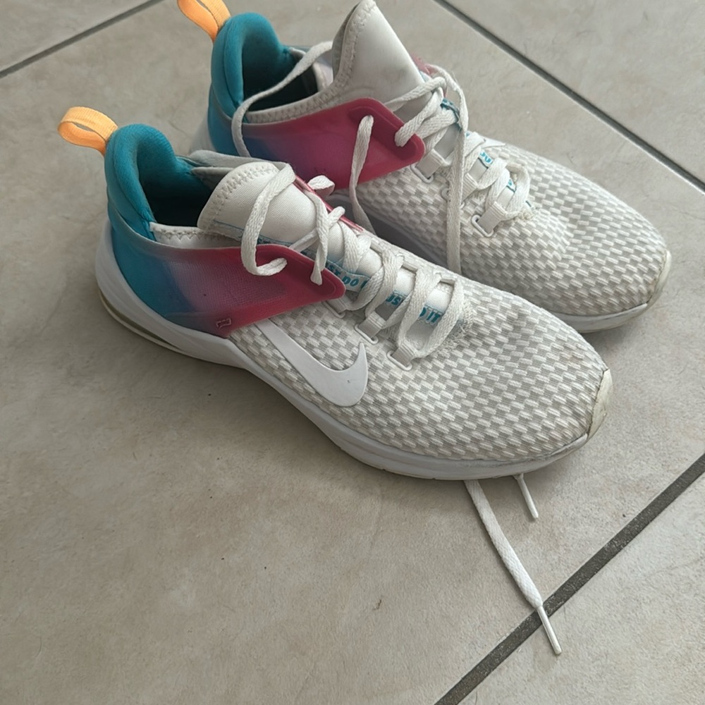 Women white pink and blue Nike running shoes